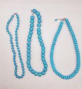 Three modern turquoise bead necklaces with silver clasps, including a large knotted barrel bead