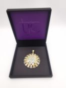 A boxed gold plated silver floral design Ethiopian opal pendant. Set with twenty seven round and