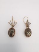 A pair of Victorian pink metal and black enamel foliate design earrings, with shepherd hook