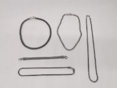 A collection of contemporary silver rope chains of various designs, including a rope design bracelet