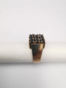 A sapphire and 9ct rose gold 1970s dress ring, set with nine round mixed cut sapphires with a