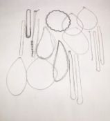 A collection of seventeen contemporary silver chains and bracelets of various designs and lengths.