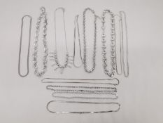 A collection of thirty three 20th century silver chains and necklaces of various designs and