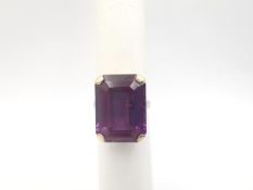A 9ct rose gold synthetic colour change sapphire cocktail ring, the gallery with a scrolling foliate