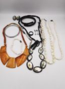 A collection of Chinese and tribal jewellery, including a pair of pink coral and silver drop