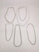 A collection of six contemporary silver chains of various designs and lengths. A ring chain link