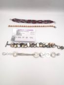 A collection of four silver bracelets, a tangerine opal tennis bracelet, a ruby and silver bead