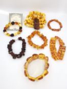 A collection amber bracelets, one with a certificate. Two amber rectangular panel bead bracelets and