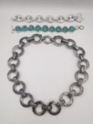 An engraved 20th century silver chain link necklace along with a statement mariner chain bracelet