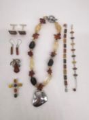 A collection of silver and amber jewellery, including a three colour amber and silver cross