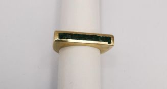 A 20th century sculptural 9ct yellow gold and emerald dress ring. Set with eight square mixed cut