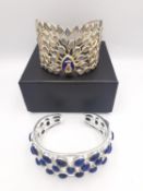 Two 20th century silver gem set bangles, one gold plated with a pierced design in the form of a