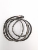 An early 20th century French white metal (tests as silver) plaited wirework snake bangle. The