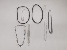 A collection of seven contemporary silver chain necklaces and bracelets of various designs and