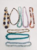 Eight 20th century gemstone bead necklaces with silver clasps, including Amethyst, Citrine, Neon