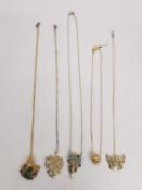 Five gold plated silver gem set pendants with chains. A golden knot pendant, a leaf with a frog