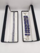 Two boxed gem set silver bracelets, one set with tanzanite and one set with lapis lazuli. Both