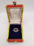 A boxed 9 carat yellow gold opal and garnet cluster ring. Set to the centre with an oval mixed cut