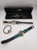 Four fashion watches, including a BOY London watch. One missing the glass back.