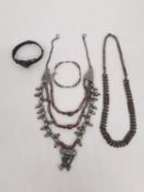 A collection of Indian and Yemeni Bedouin silver jewellery, including a silver and coral multi