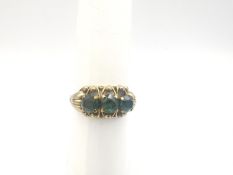 A 9ct yellow gold tourmaline set three stone dress ring, set with three round mixed cut