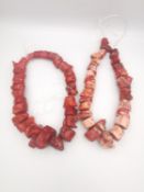 Two strings of large red and pink branch coral beads, one string comprised of twenty seven beads,