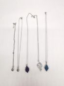 Five silver gem set pendants with chains. A white topaz set snake pendant, an amethyst floral