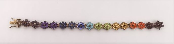 A gold plated silver gem set articulated flower chain bracelet, each of the flowers set with a