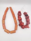 Two strings of red and orange coral beads. One string comprises of fourteen red coral chunk beads