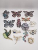 A collection of thirteen contemporary paste set brooches, including butterflies, a monkey, birds and