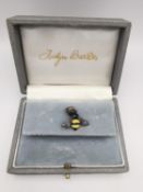 Jocelyn Burton, a leather boxed silver and enamel bumble bee pin with a honeycomb push back.