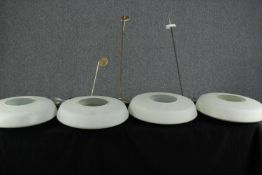 Four large ceiling lights with opaque white glass shades. Twentieth century. Each with a diameter of