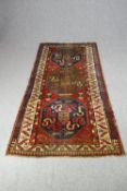 Hall rug or runner, Shirvan with stylised lozenge medallions on a madder ground within stylised