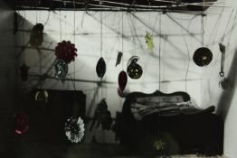 Framed photograph. Unsigned. A hanging mobile of stars and shapes. An interesting composition with