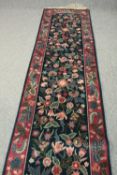 A William Morris design runner with profuse flowerhead decoration. L.540 W.79cm.