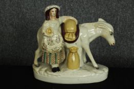 Staffordshire figure. 'Beesom'. A pedlar and donkey carrying sand. Circa 1880. H.21 x W.21 cm.