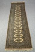 Runner, Bokhara with repeating gul motifs in flowerhead multiple borders. L.310 W.85cm.