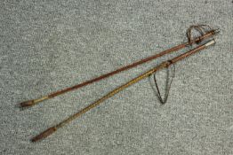 Two early 20th century leather riding crops, one with a white metal end. L.69cm.