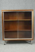 Dwarf bookcase, mid century teak on chrome supports. H.108 W.93 D.38cm.