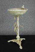 A iron birdbath with a decorative stand and a bird perches on the rim. H.60 Dia.32 cm.
