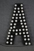 A large and illuminated letter 'A' with over 50 bulbs. In working order. H.125 W.75 cm.