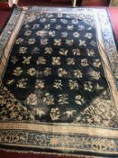 A large vintage Chinese woollen carpet. L.520 W.380cm. (Patches of wear as seen).