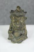 A Victorian novelty brass table lighter in the form of Punch, hat comes off to reveal lighter.