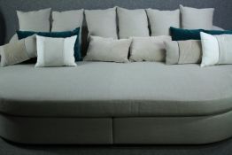 Daybed sofa, contemporary upholstered with a large collection of cushions. H.80 W.275 D.180cm.