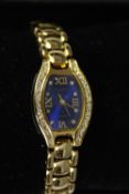 Two boxed fashion watches, one with a gold tone articulated bracelet, midnight blue face and