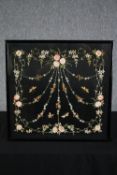 A framed embroidery. An intricate floral design on a black background. Framed and glazed. H.53 W.