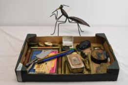 A collection of miscellaneous items including compacts, a frame and others. The largest H.27 W.34