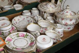 An incomplete china tea set including a teapot, cups and saucers and creamer. With floral decoration
