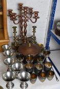 A collection of metal wear to include shot glasses, goblets, candle sticks, candelabra and ice