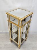 A mirrored glass and gilt pedestal cabinet. H.90 W.40 D.40cm.
